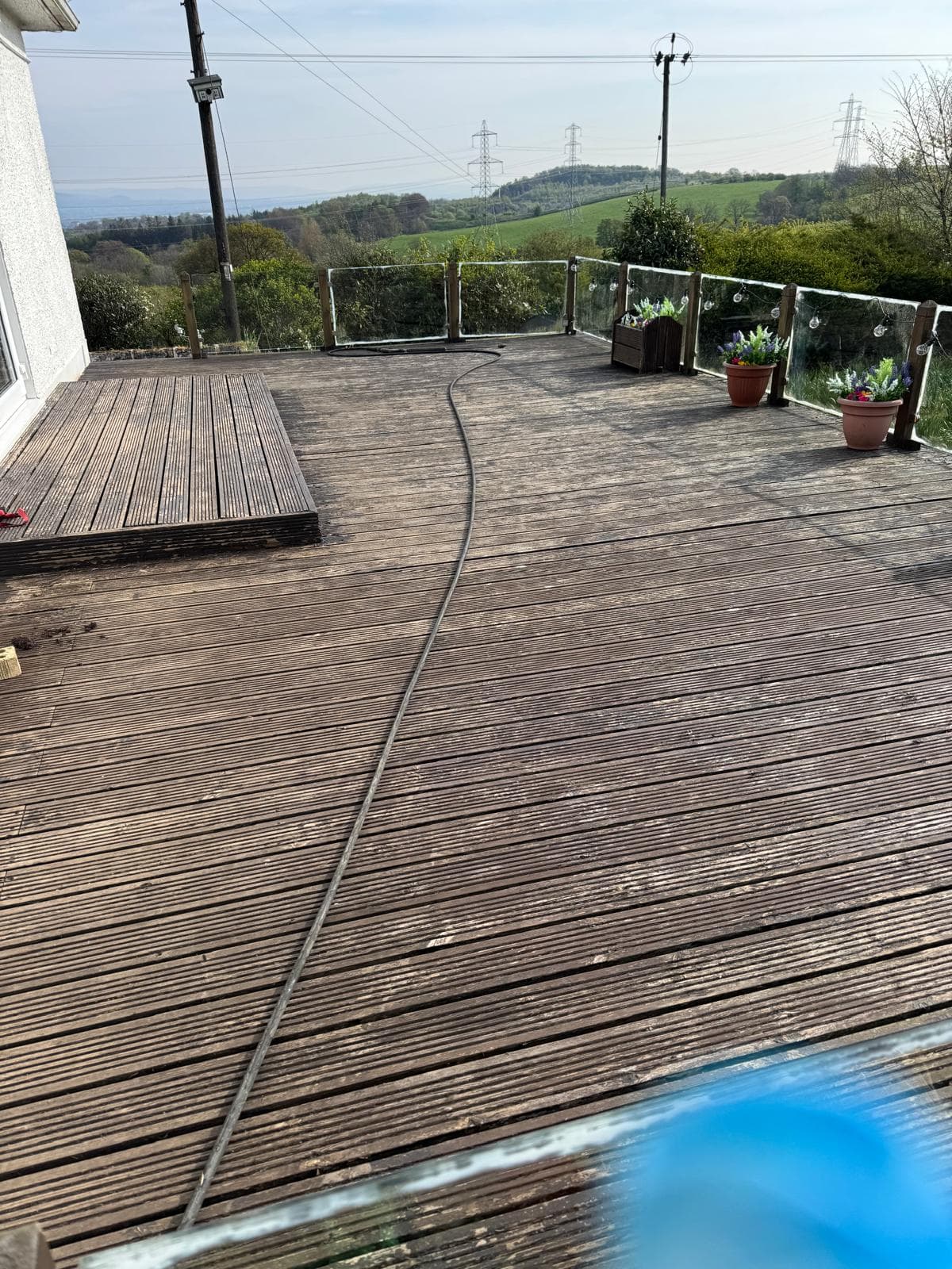 Weathered grey decking before wash