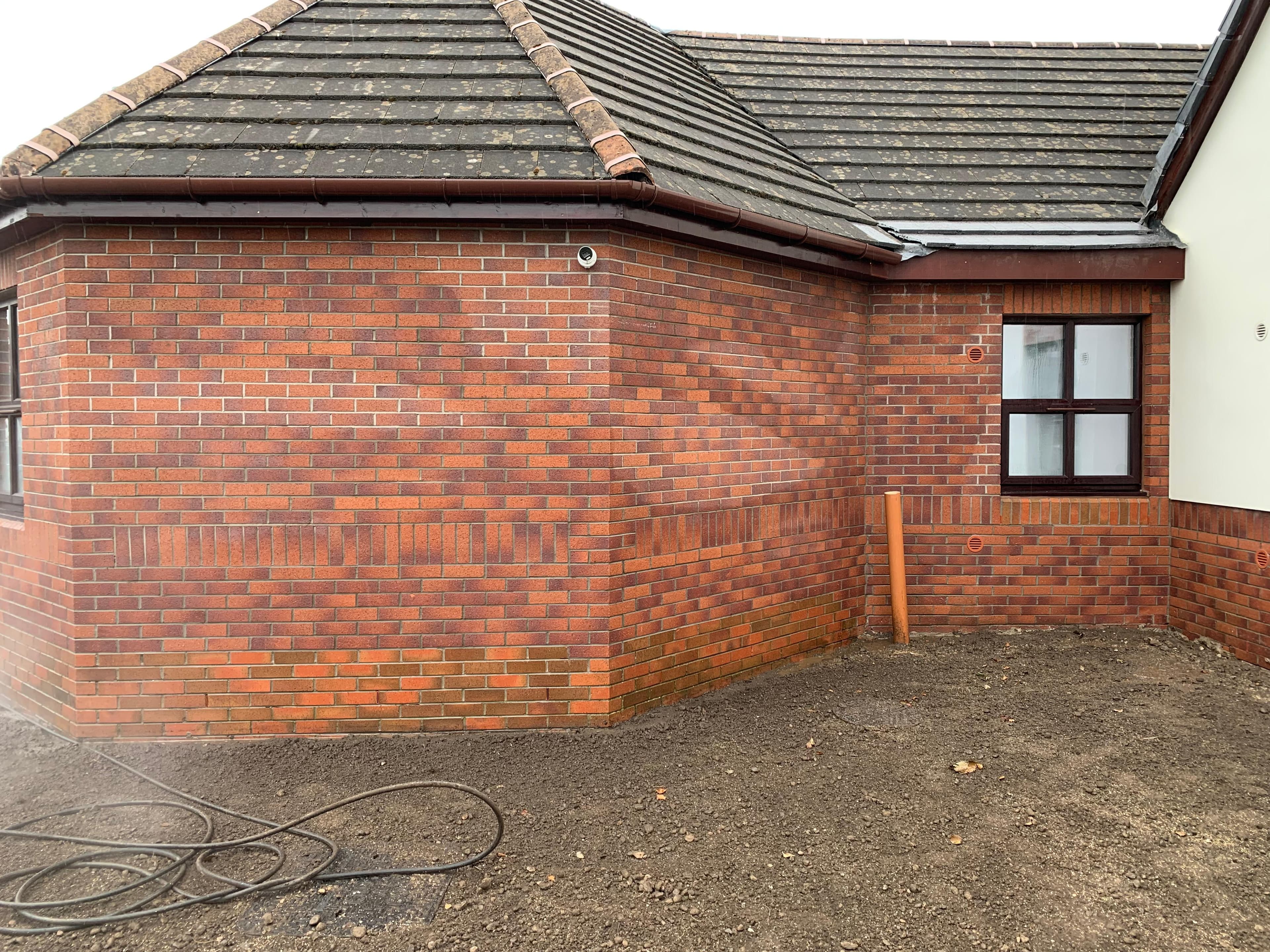 Cement splatter being lifted from brickwork
