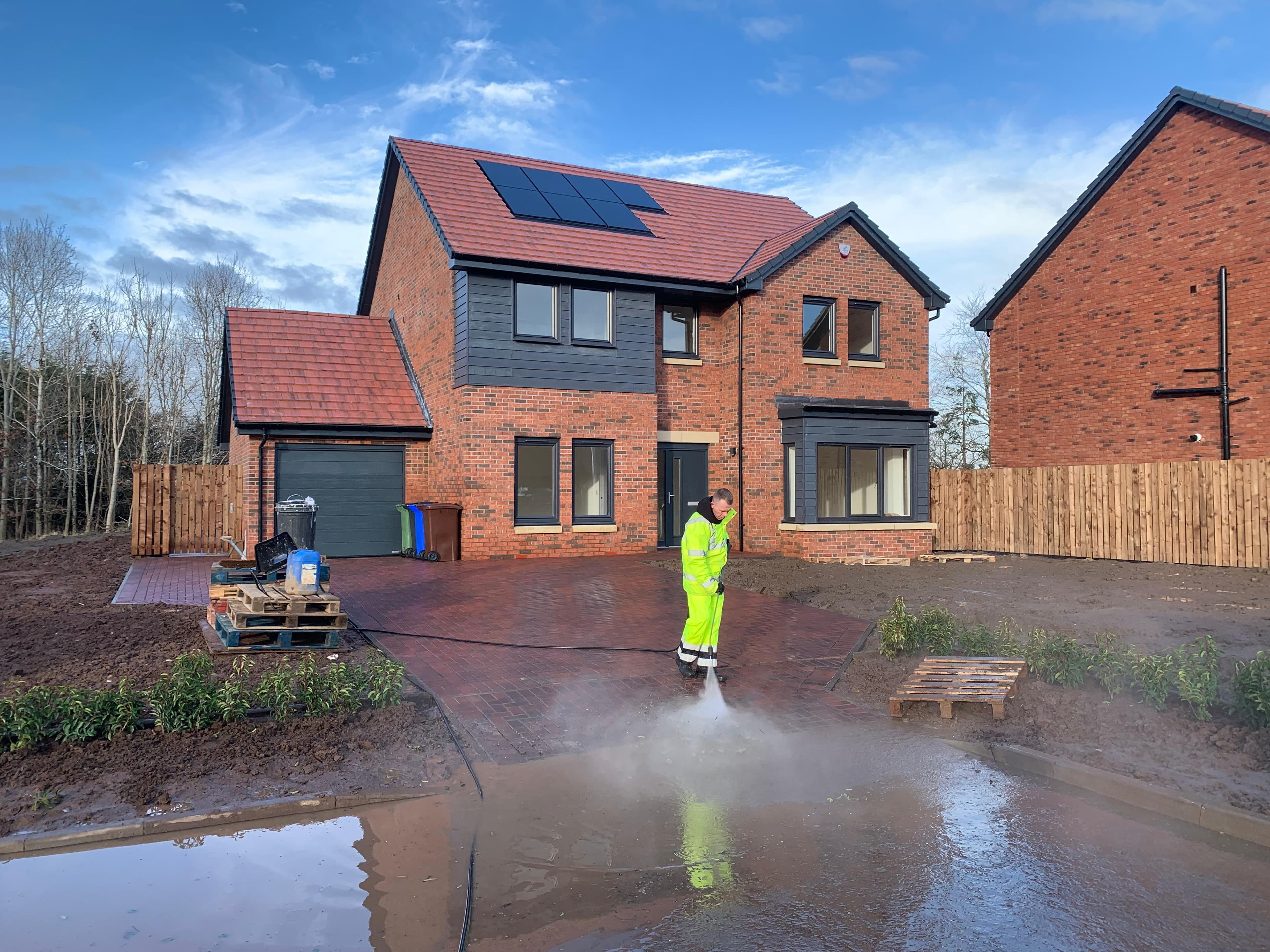 Builders' silt being washed from driveway