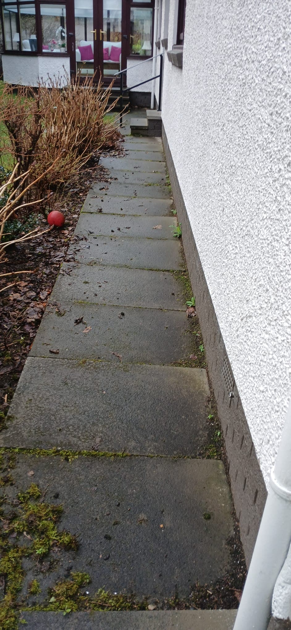 Bright red herringbone driveway after wash