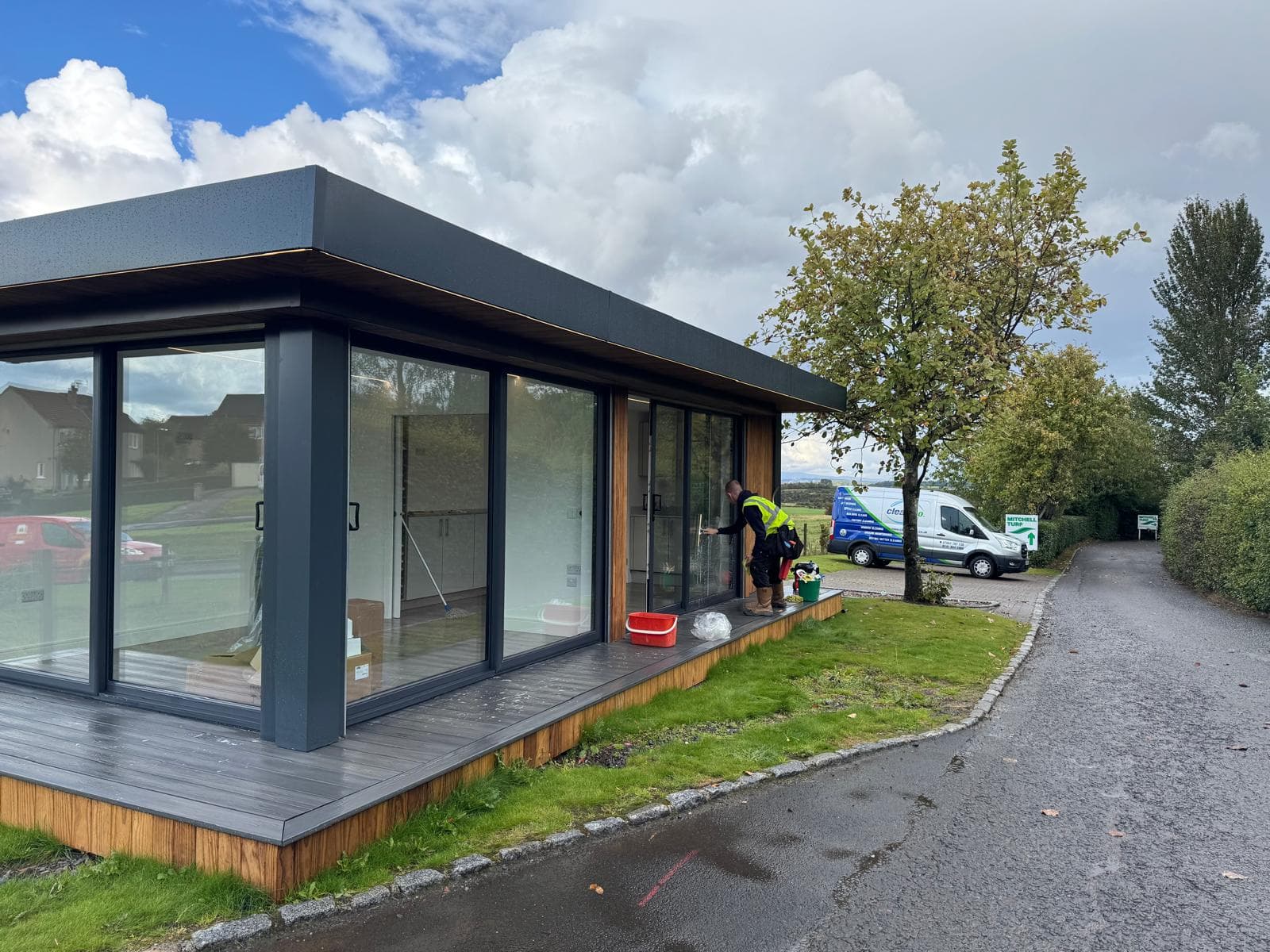 CleanCo team cleaning sales pod glazing