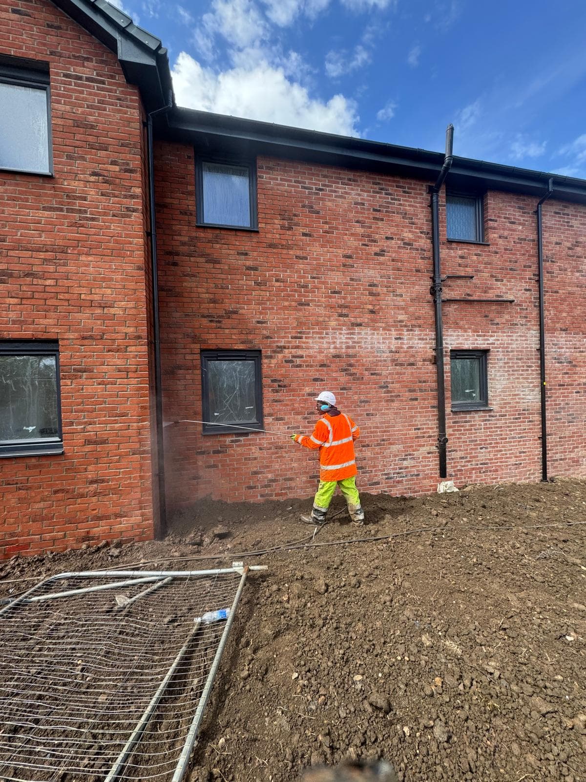 Cement haze being lifted from red brick