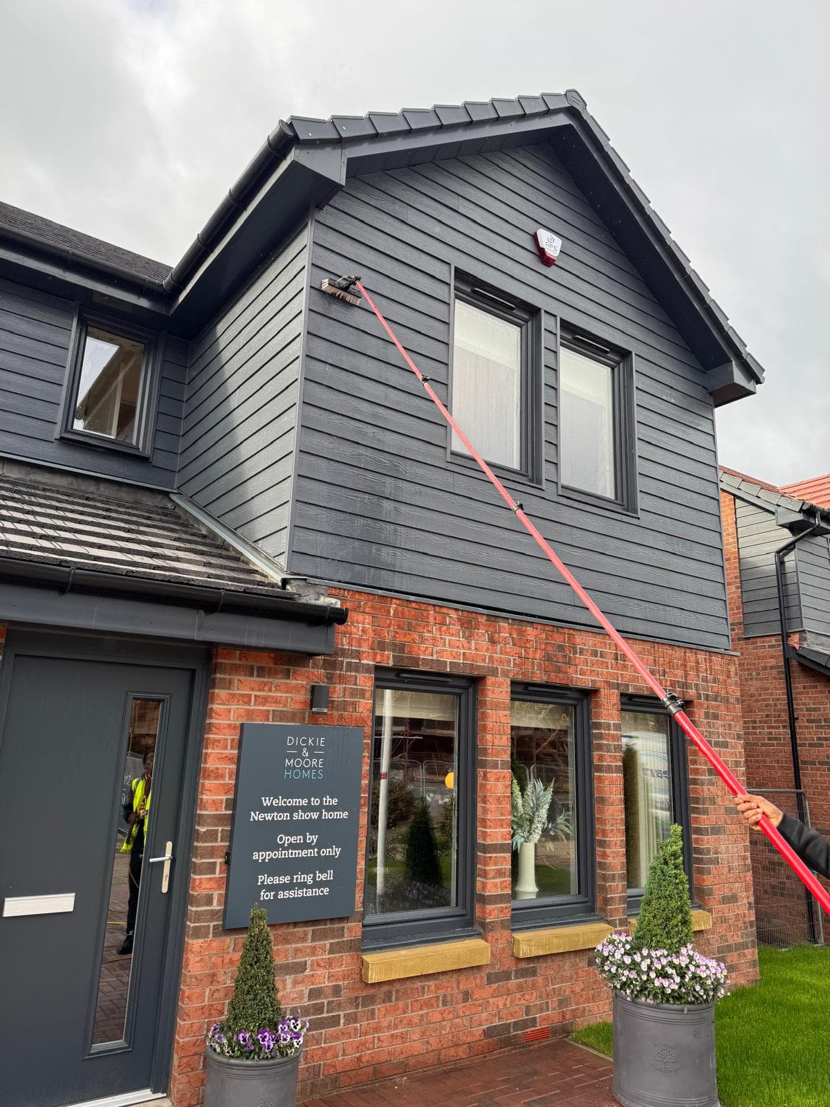 Cleaning the dark-clad gable windows