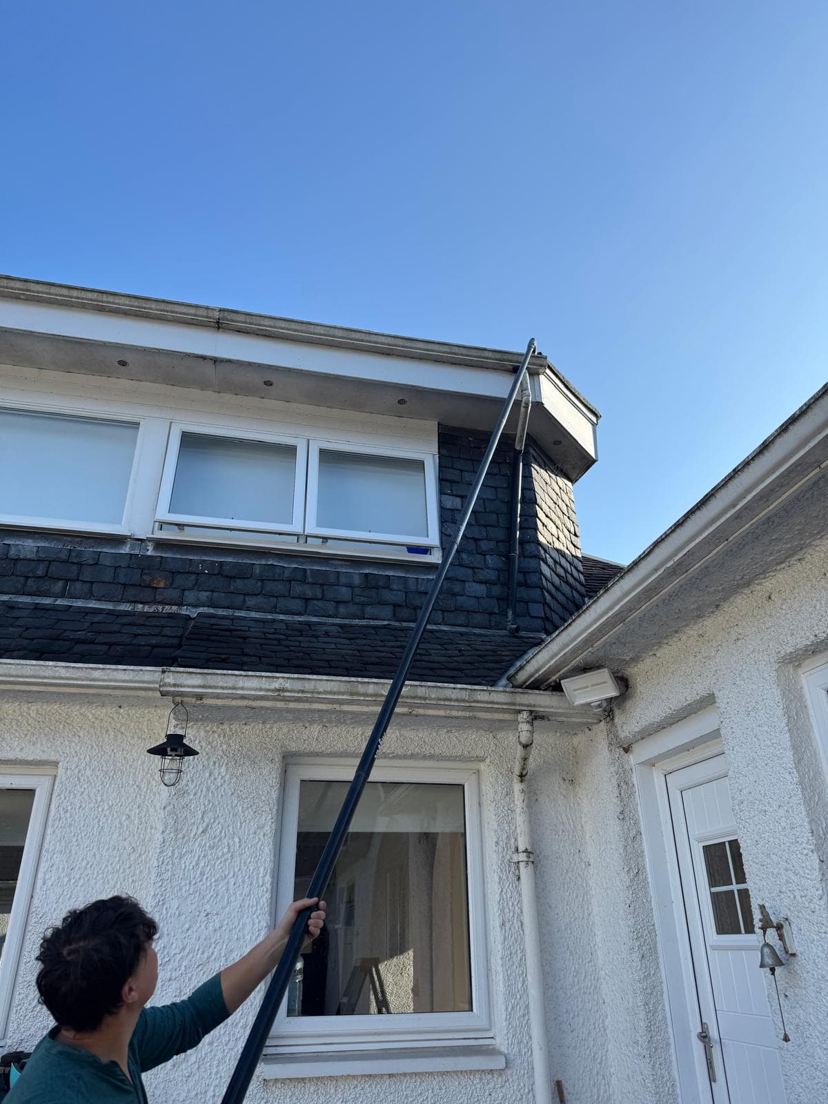 Compacted leaf and moss being extracted from a gutter